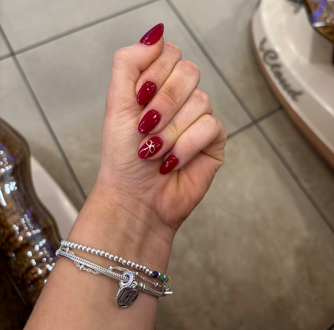 Deep red almond manicure with white accent line