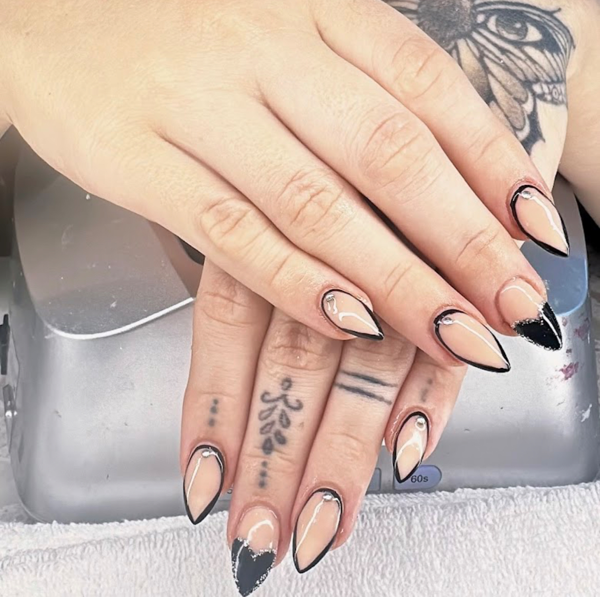 Nude almond nails with black outline tips