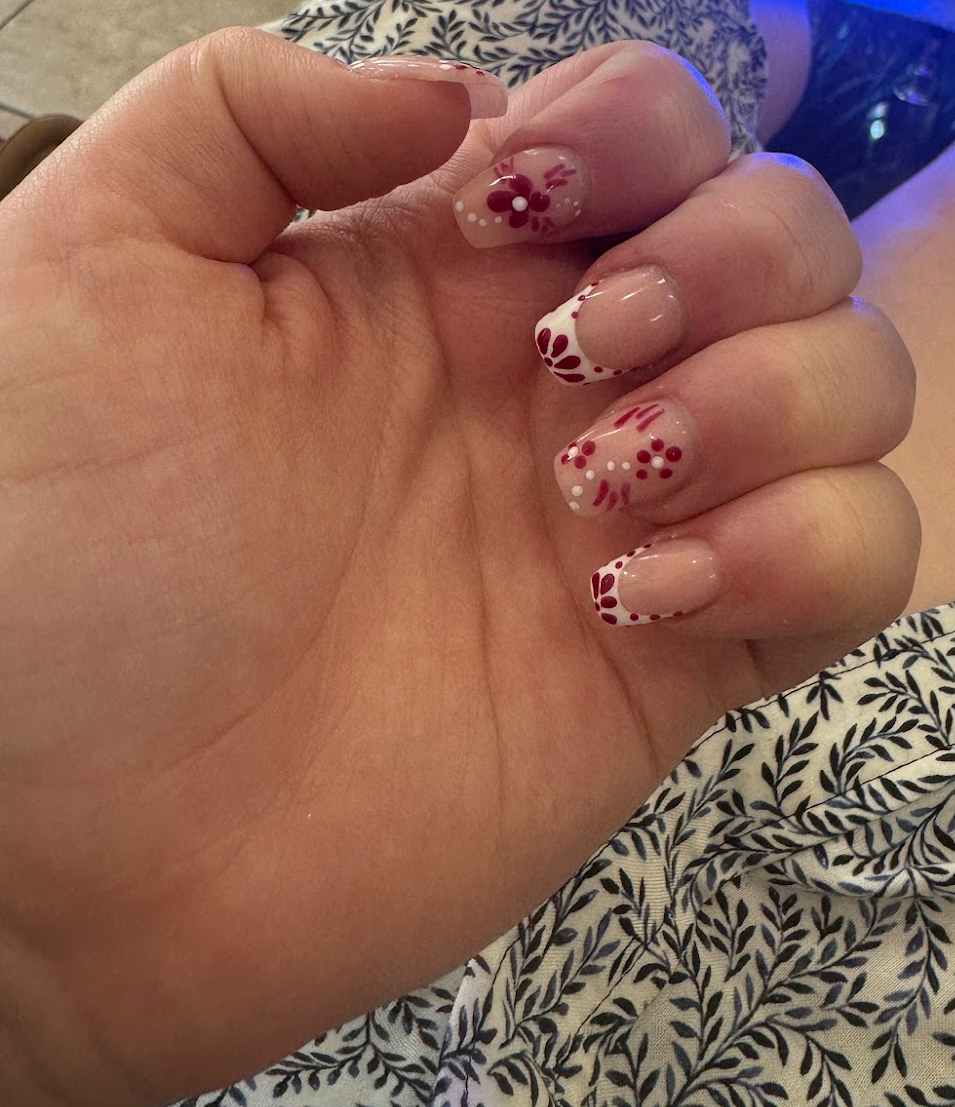 Burgundy floral french manicure close-up